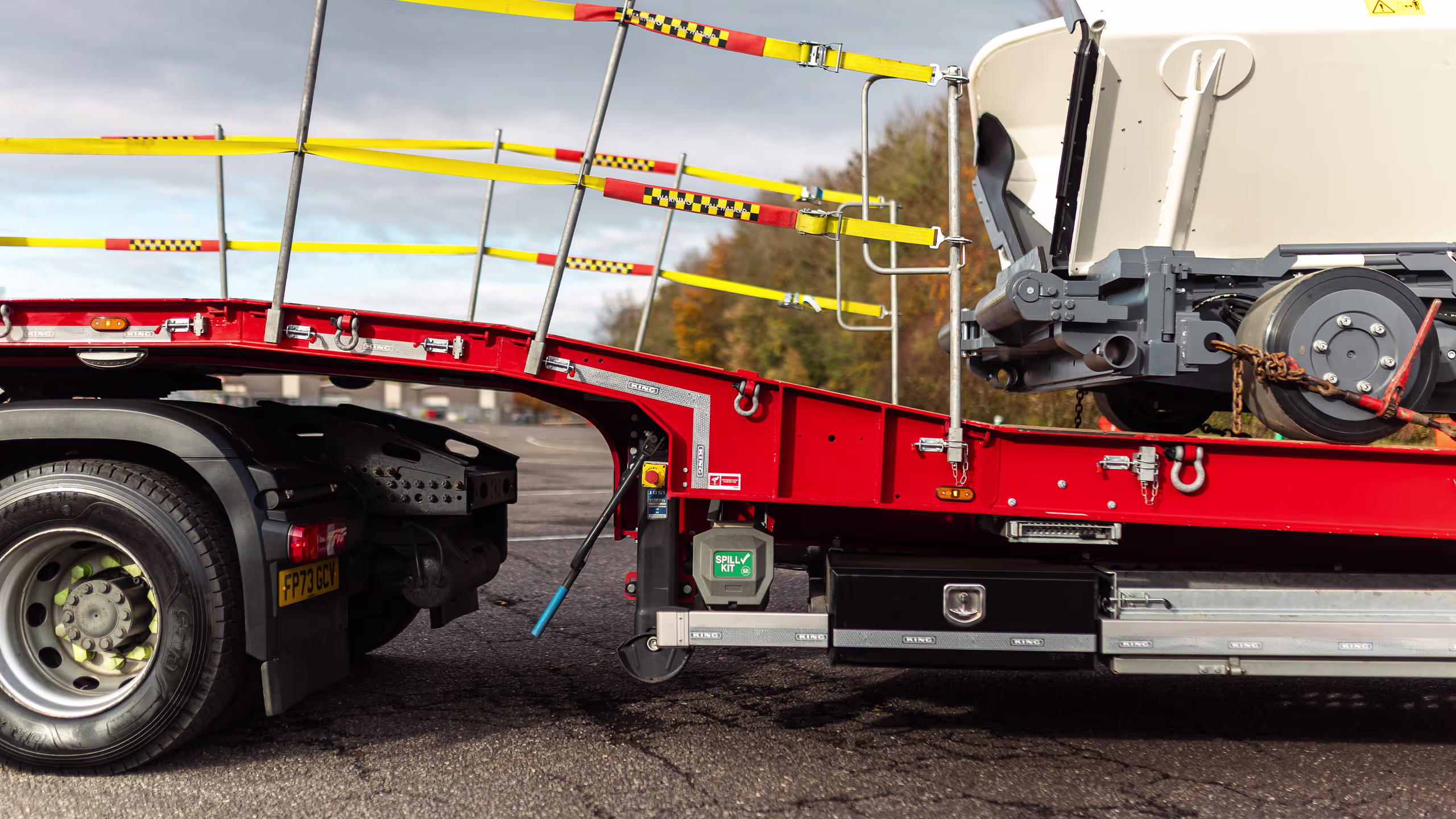 King GTSS44 semi-sloper trailer with hydraulic fliptoe ramps and side rave furniture.