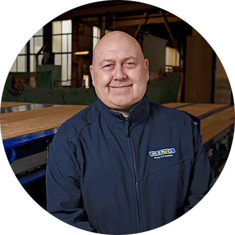 Paul Ribbons, King Trailers production manager, smiling in workshop environment.