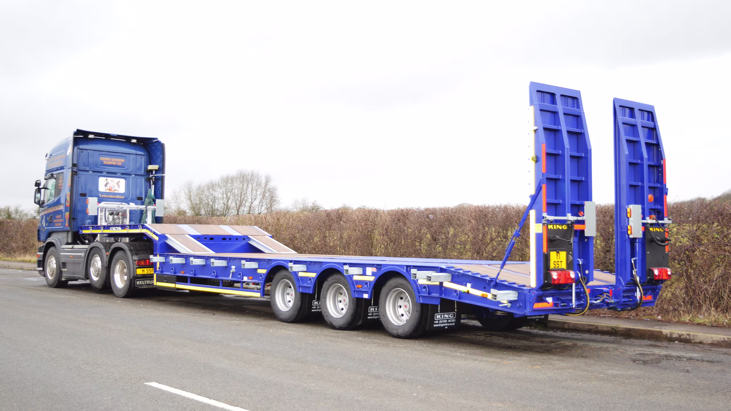 King GTS60 stepframe low-loader trailer with hydraulic fliptoe ramps and heavy-duty axle configuration.
