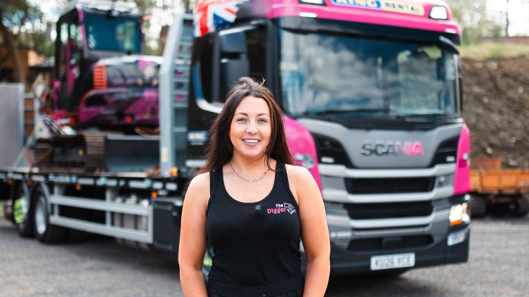 King Trailers partnership with The Digger Girl, woman standing proudly in front of Scania truck and trailer.